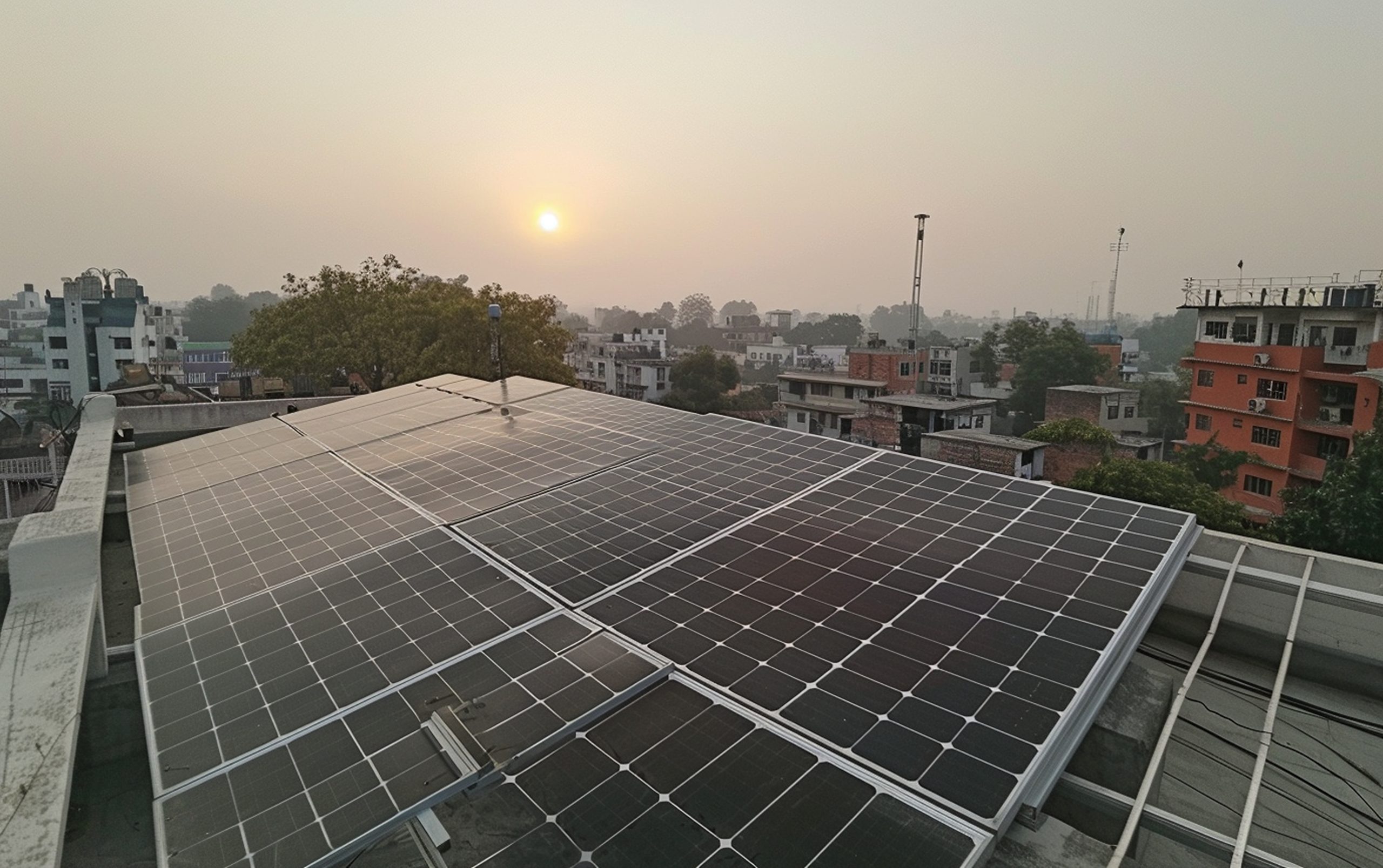 Rooftop solar panels under clear blue sky